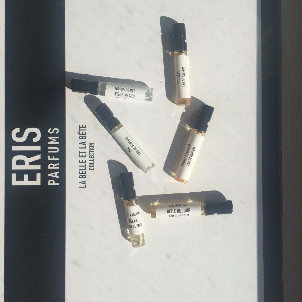 An assortment of sample size perfume spray bottles labelled with Eris Parfums branding set against a white background