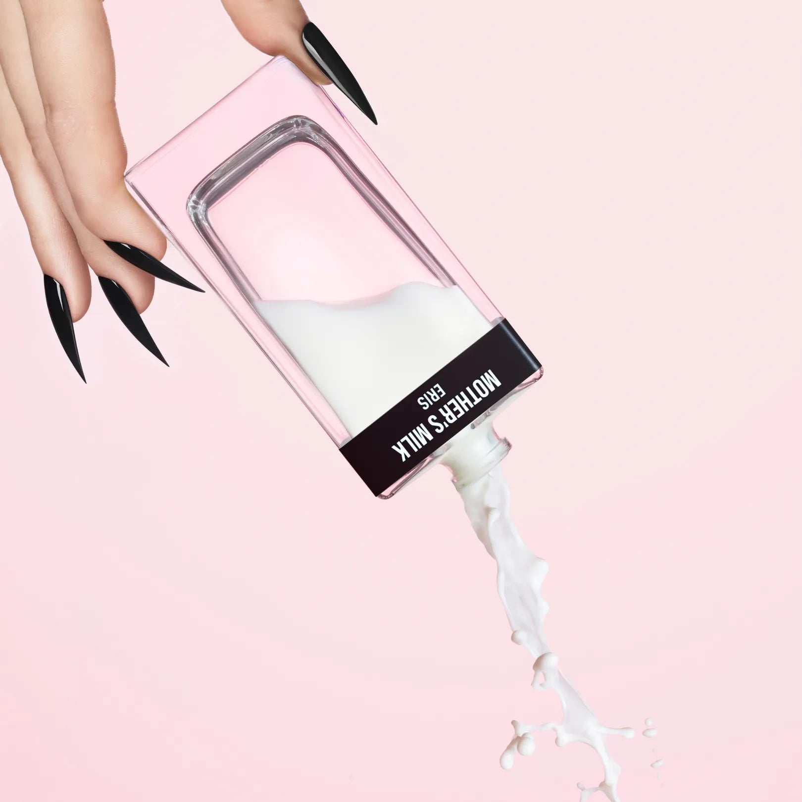 ERIS Parfums Mother's Milk Fragrance Bottle with white liquid being poured against a pink background.