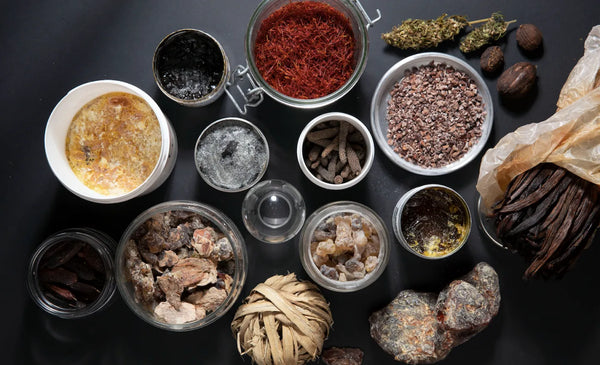 an assortment of perfume making ingredients in bottles used by ERIS Parfums taken from a birds eye view
